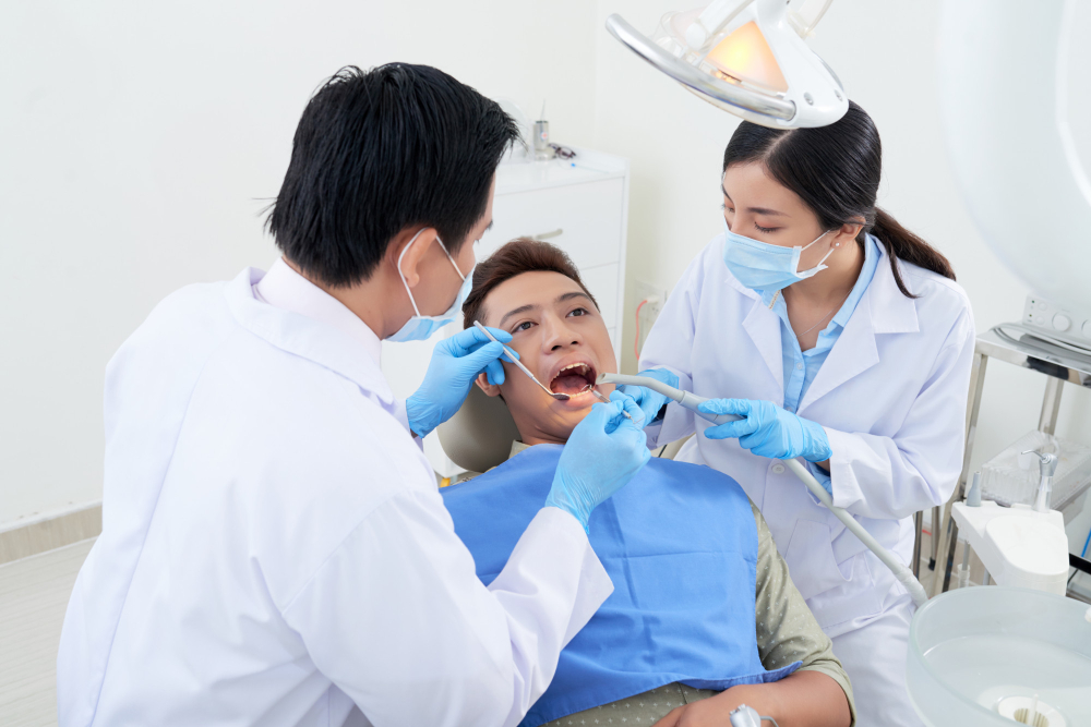 male dentist nurse examining before performing dental implants Kuala Lumpur